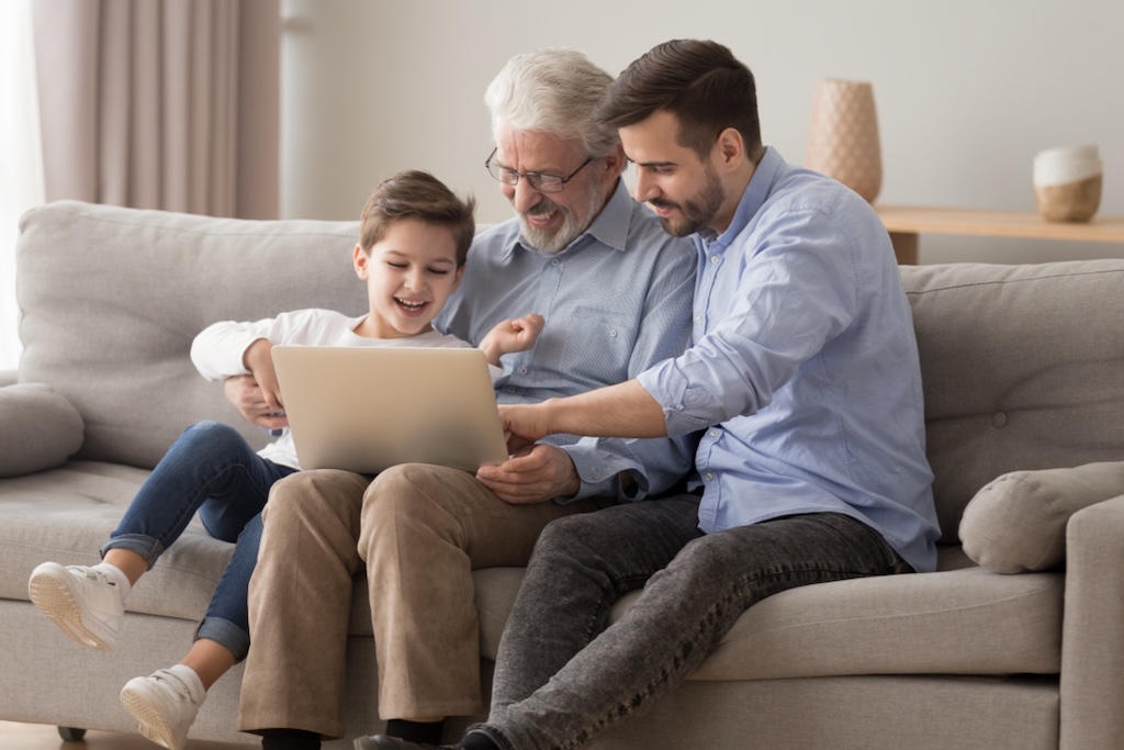 Three generations of family looking at a laptop