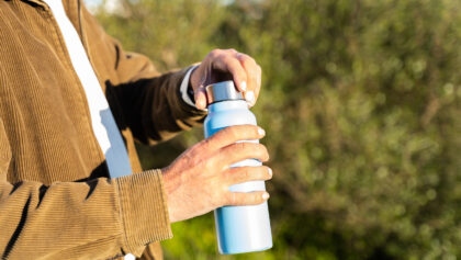 Unrecognizable man opening a water bottle